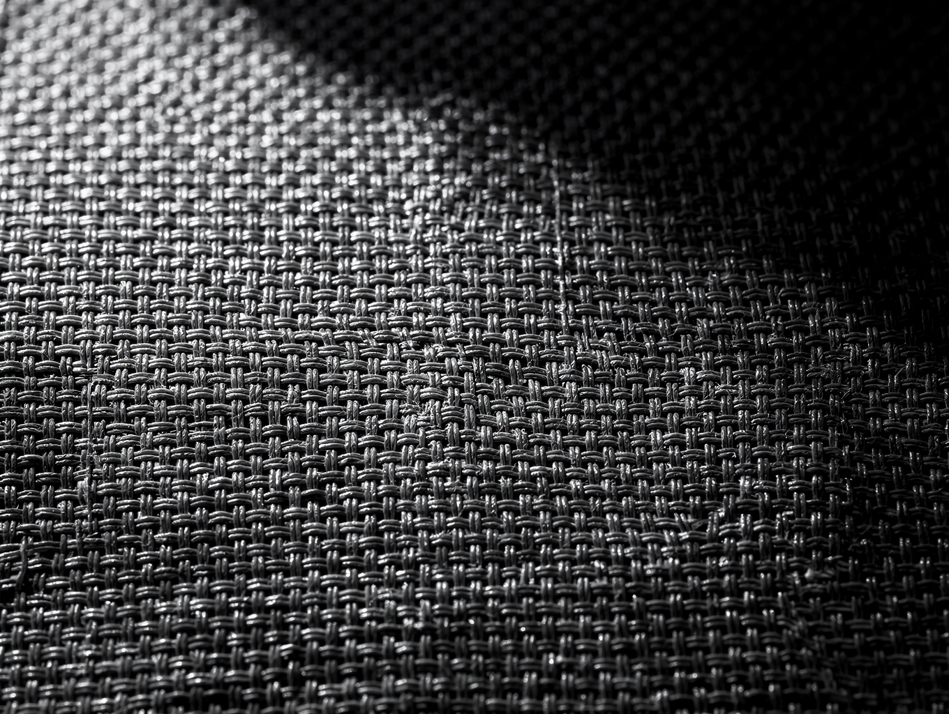 Microscopic dark weave pattern of Artemia Active Shadow-Knit textile